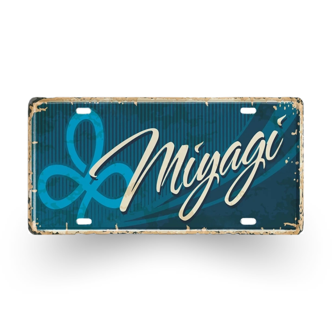 Metallic license plate with 'Migagi' branding on a blue background