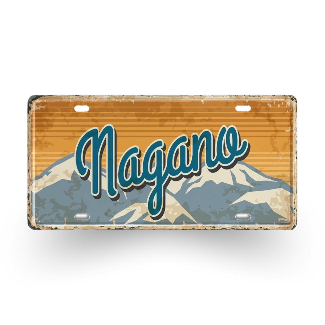 Decorative license plate with 'Nagano' text and mountain design on a white background