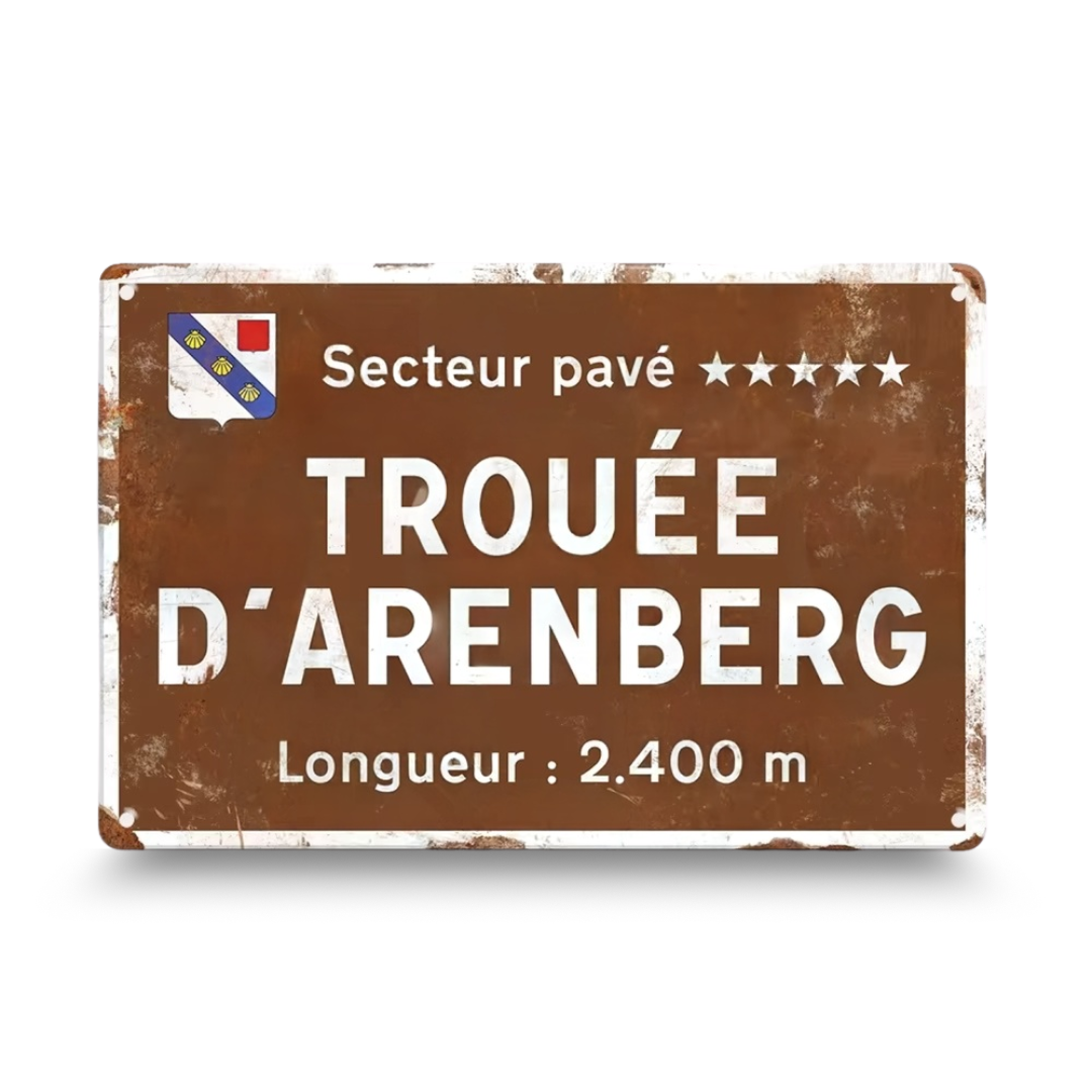 Rustic metal sign with 'Trouée d'Arenberg' text on a white background
