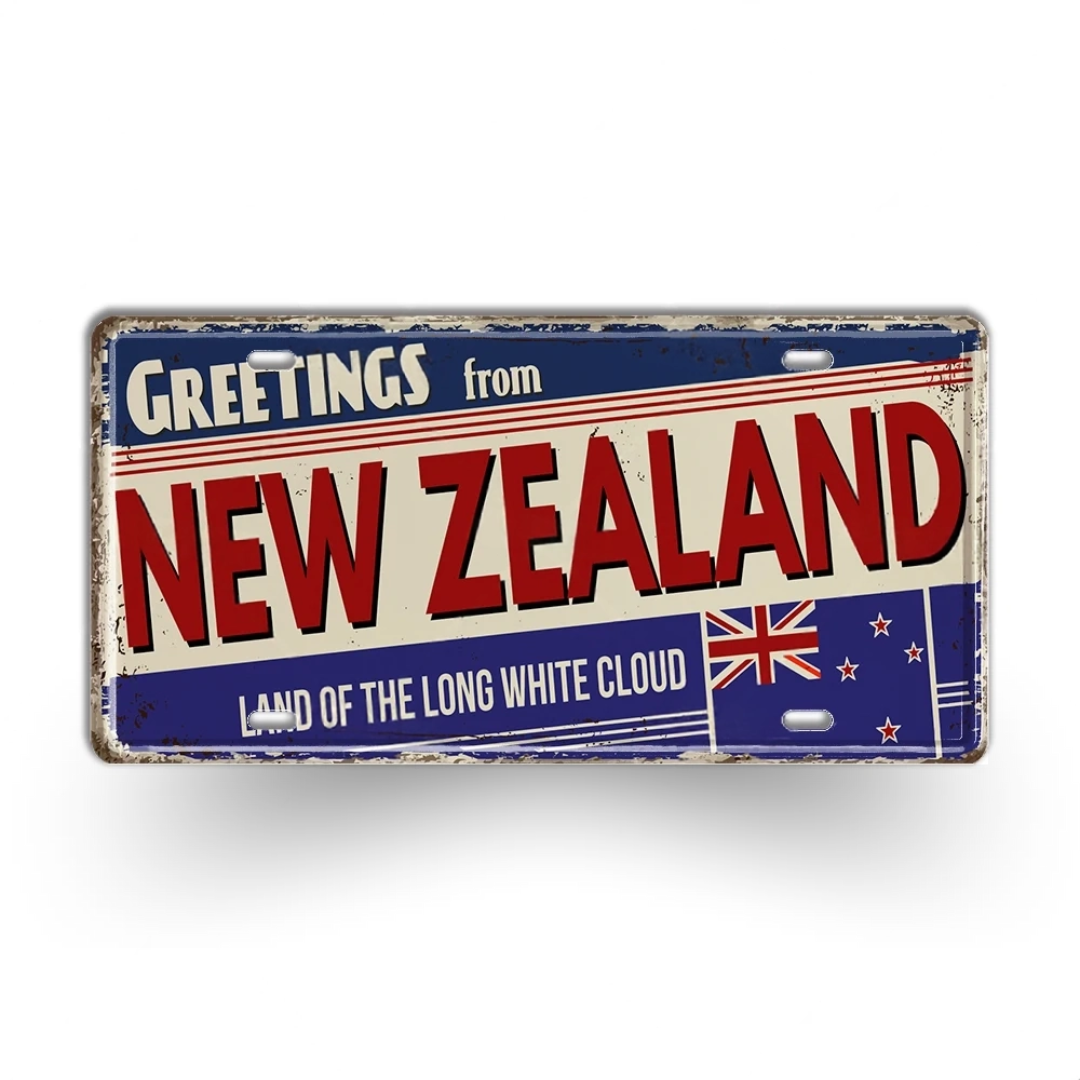 Vintage-style sign with 'Greetings from New Zealand' text and flag design on a white background