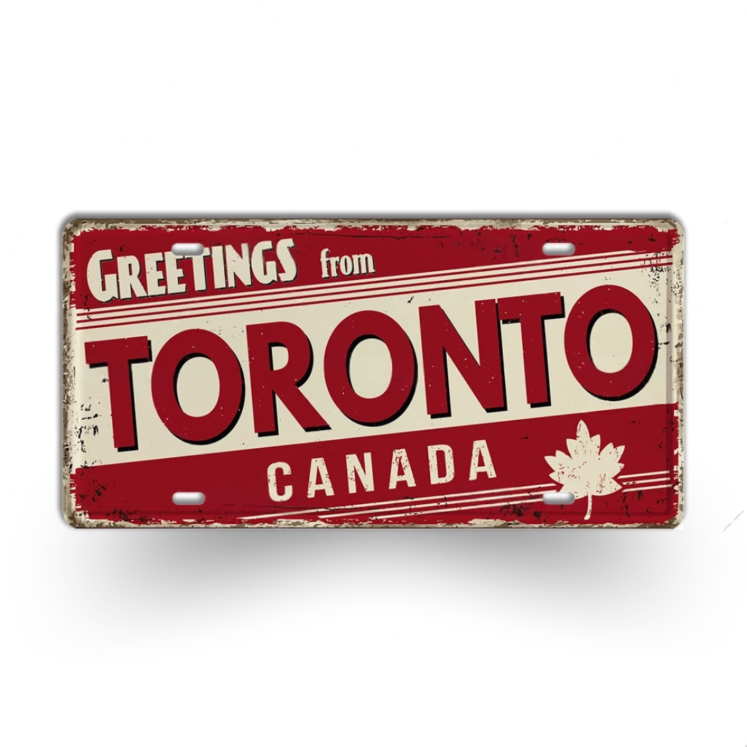 Vintage-style sign with 'Greetings from Toronto, Canada' text and a maple leaf on a white background