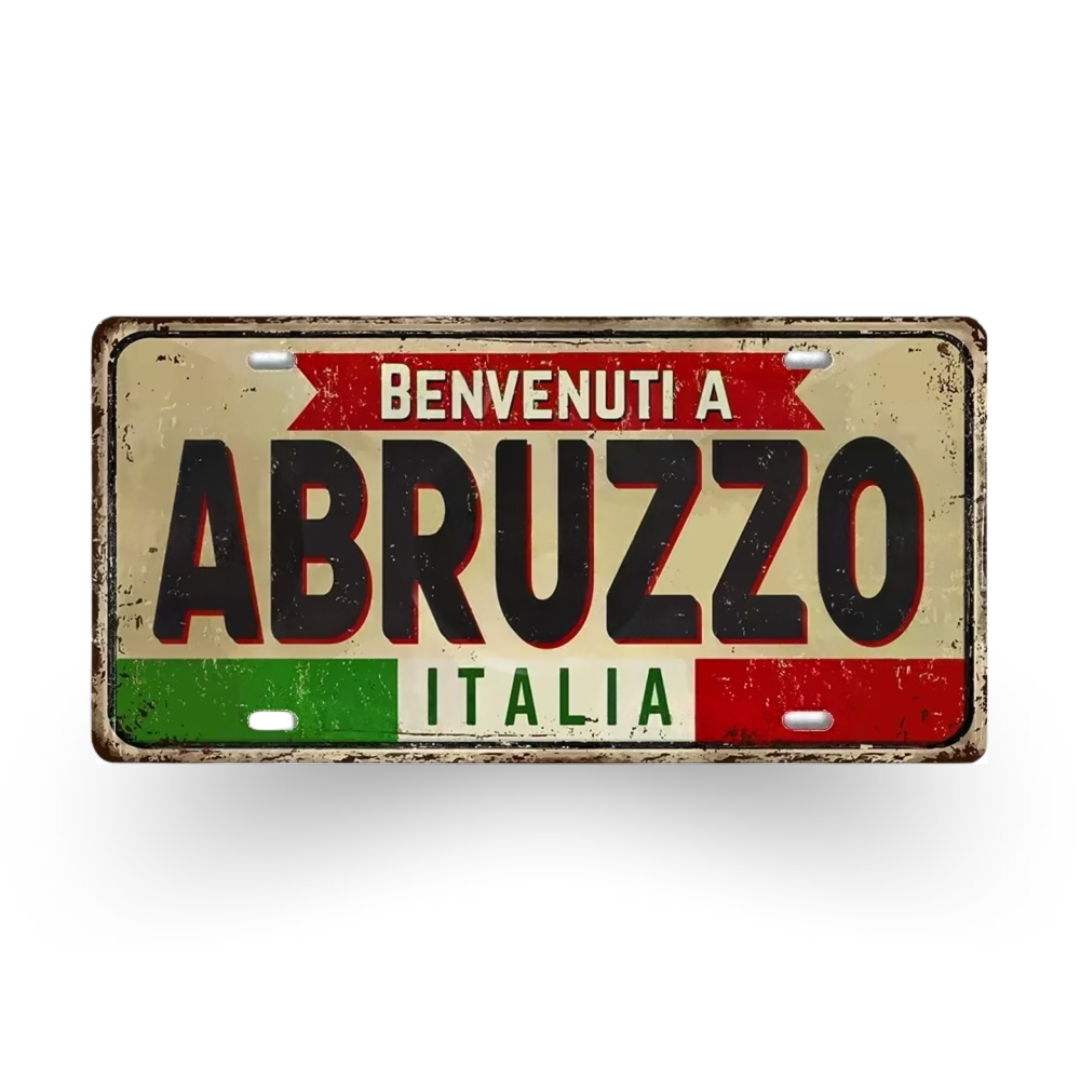 Decorative sign with 'Benvenuti a Abruzzo Italia' text on a white background