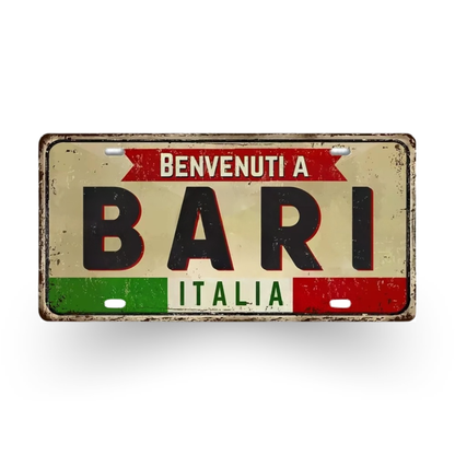 Decorative sign with 'Benvenuti a Bari Italia' text on a white background