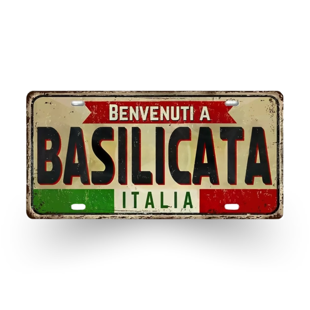 Decorative sign with 'Benvenuti a Basilicata Italia' text on a white background
