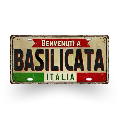 Decorative sign with 'Benvenuti a Basilicata Italia' text on a white background