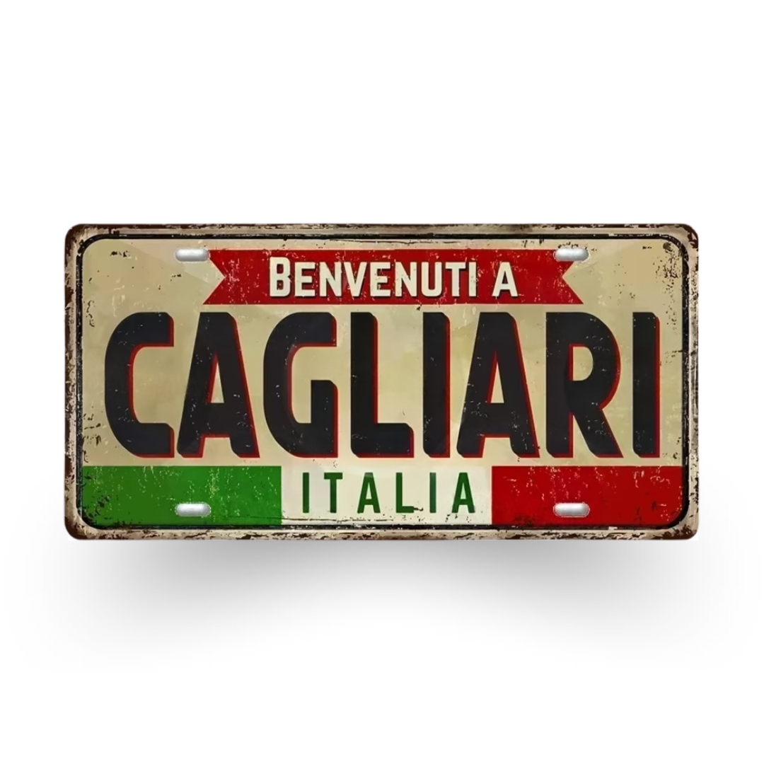 Decorative sign with 'Benvenuti a Cagliari Italia' text on a white background