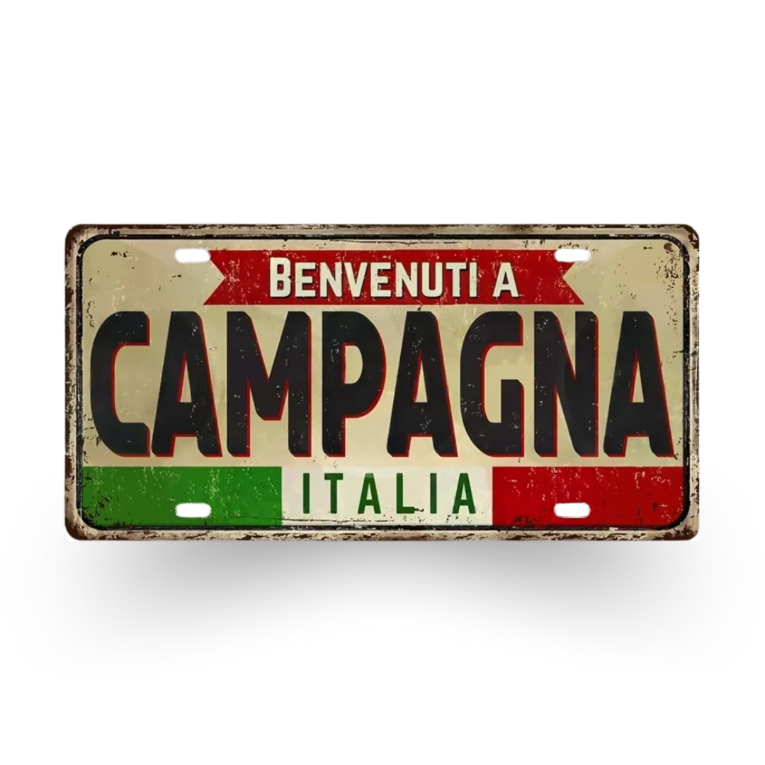 Vintage-style metal sign with 'Benvenuti a Campagna Italia' text on a white background
