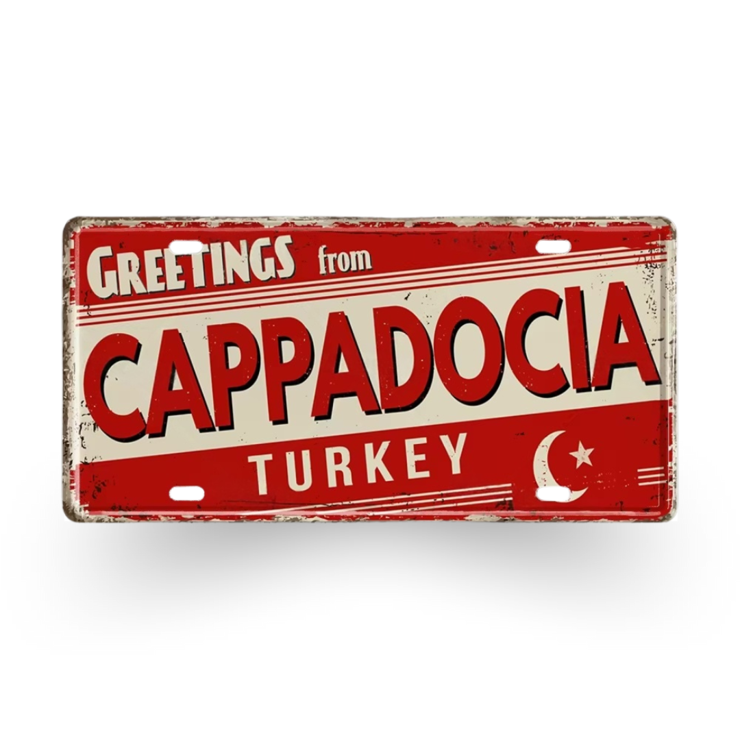 Vintage-style sign with 'Greetings from Cappadocia, Turkey' text on a red background