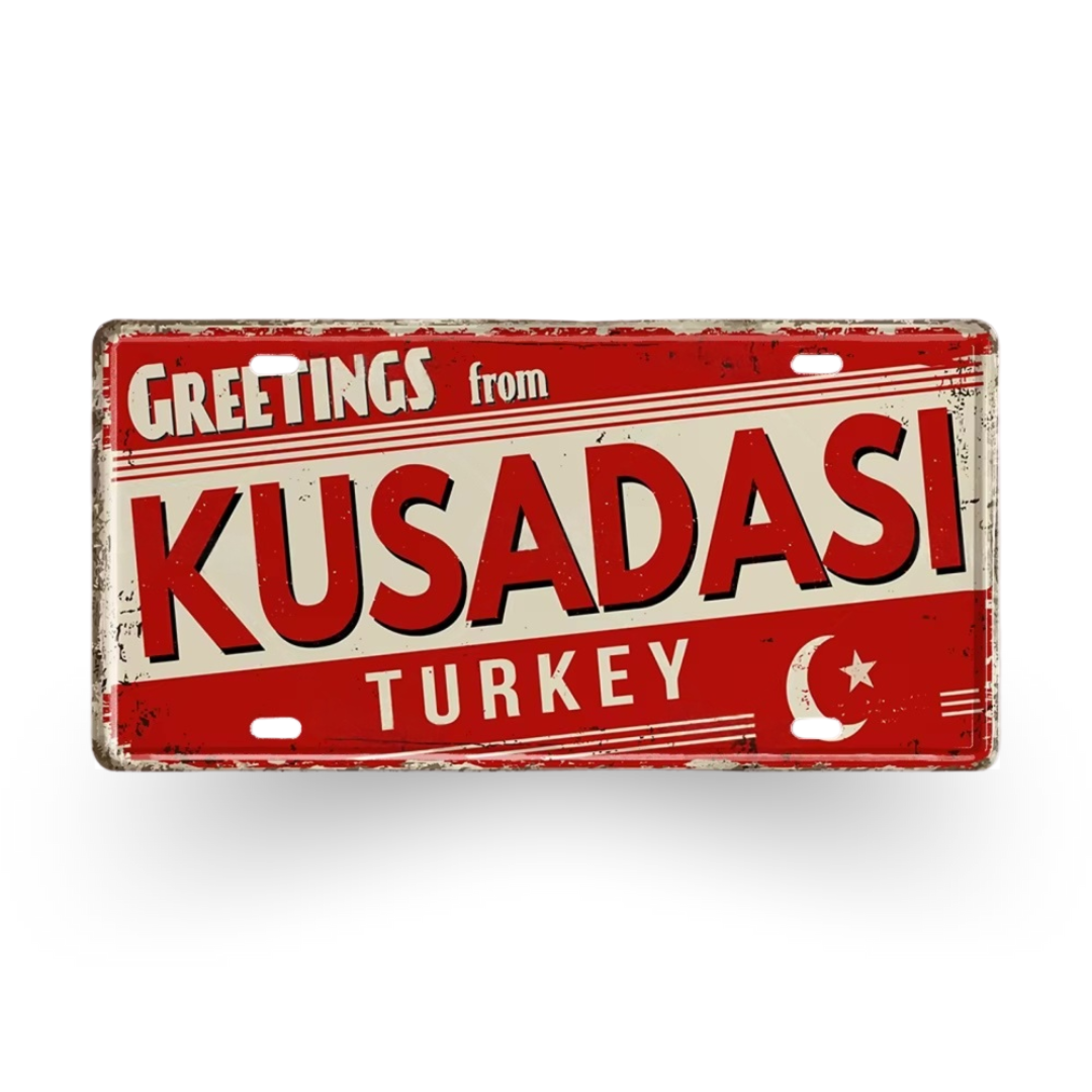 Vintage-style sign with 'Greetings from Kusadasi, Turkey' text on a red background
