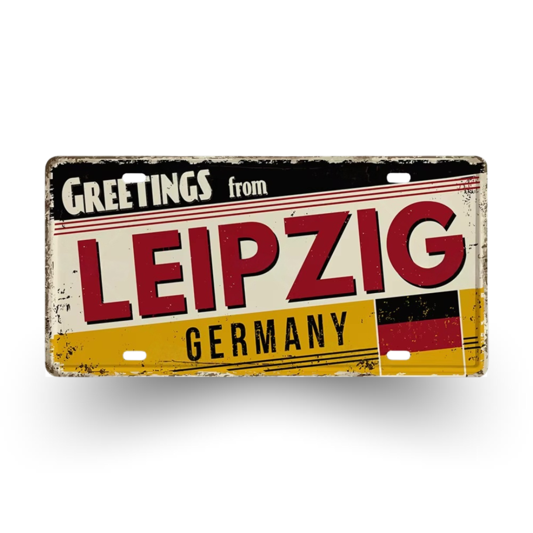 Vintage-style sign with 'Greetings from Leipzig, Germany' text on a white background