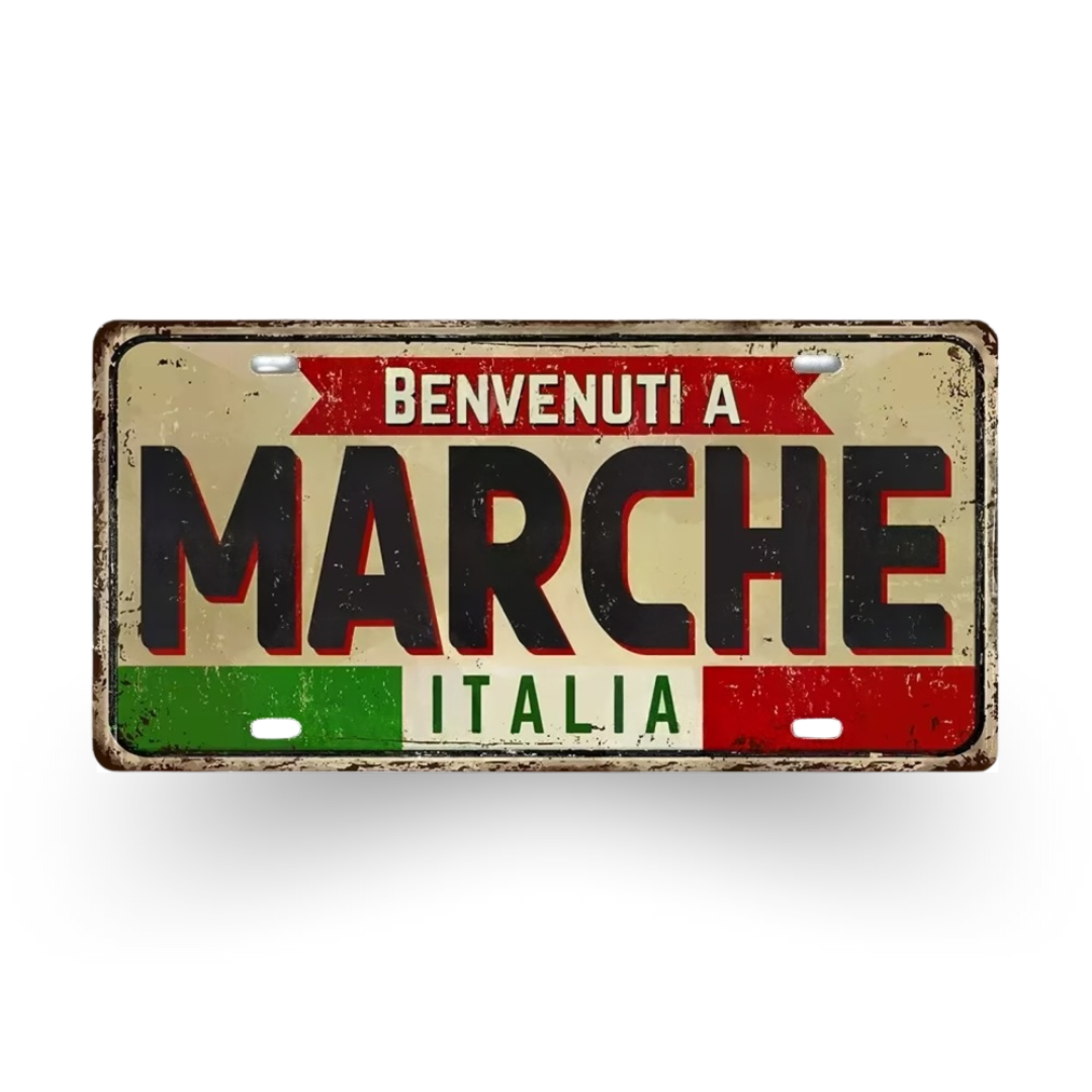 Decorative sign with 'Benvenuti a Marche Italia' text on a white background