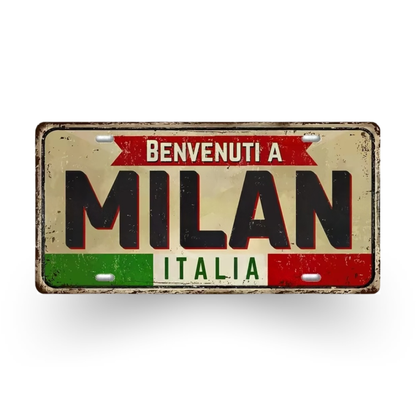 Decorative license plate with 'Benvenuti a Milan Italia' text on a white background