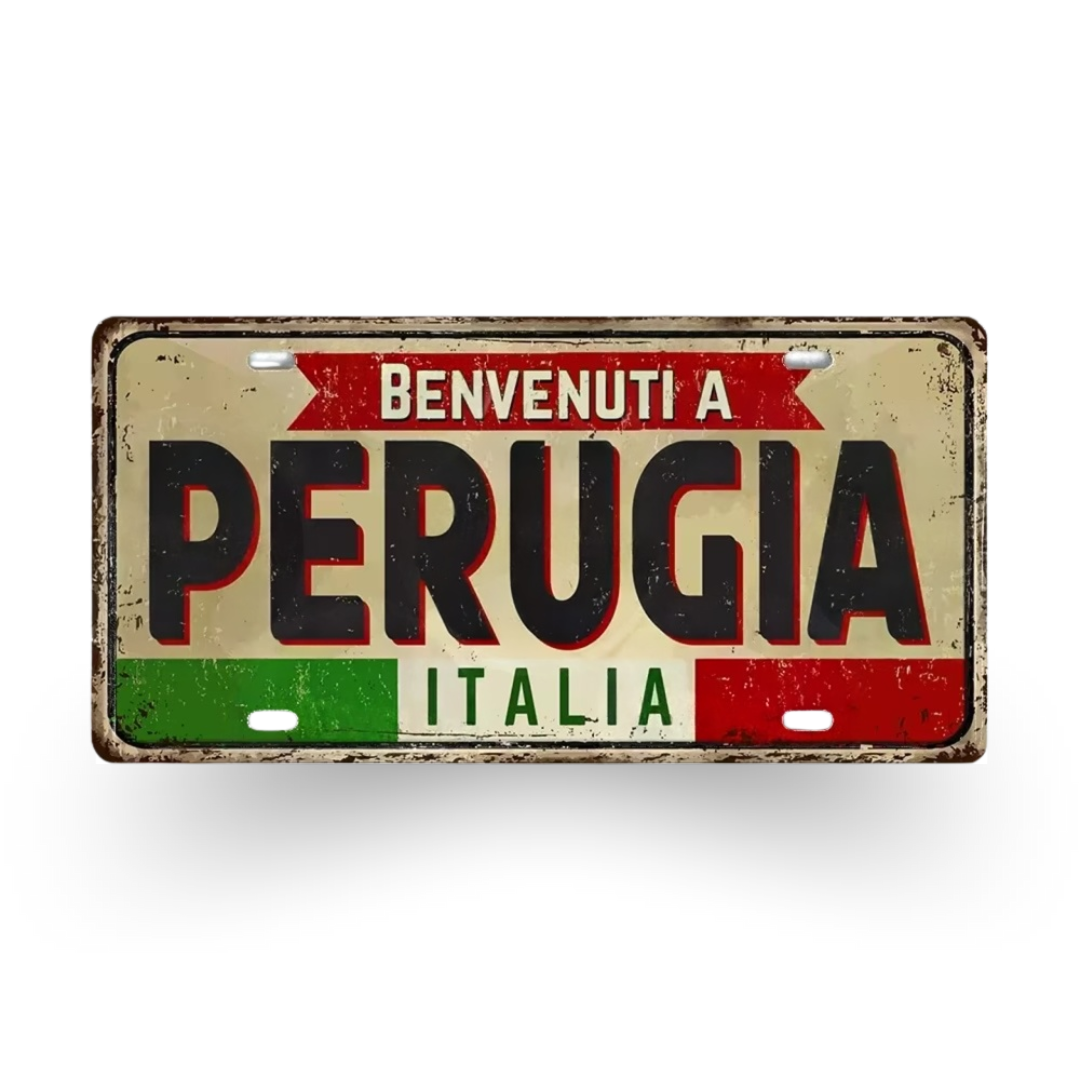 Decorative sign with 'Benvenuti a Perugia Italia' text on a white background