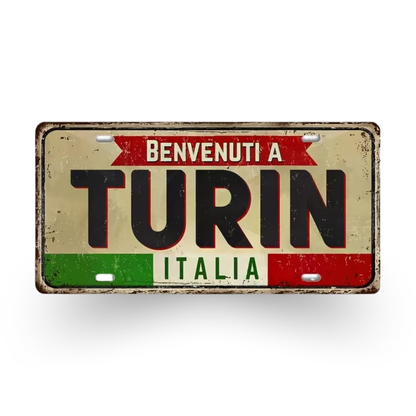 Decorative sign with 'Benvenuti a Turin Italia' text on a white background