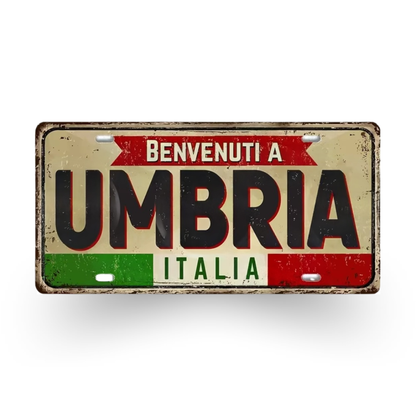 Decorative sign with 'Benvenuti a Umbria Italia' text on a white background