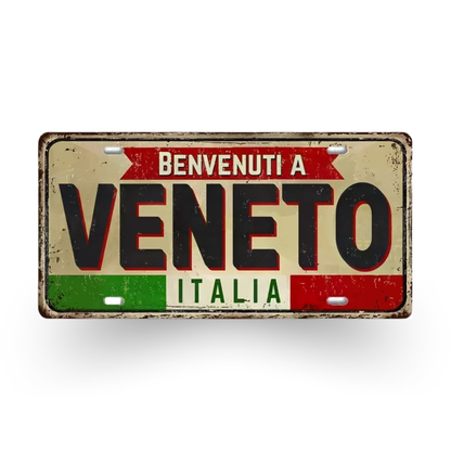 Decorative sign with 'Benvenuti a Veneto Italia' text on a white background