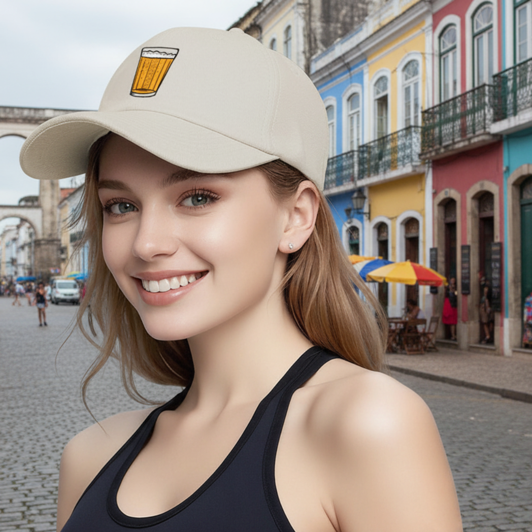 Woman wearing a beige cap with a beer mug emblem in an urban setting