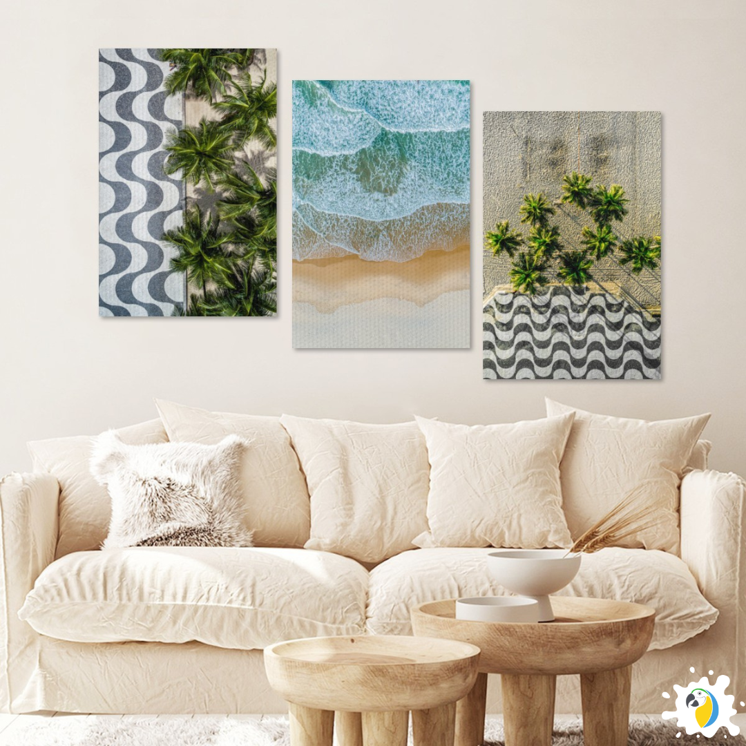 A cozy living space showcases a sand-toned sofa alongside rustic wooden coffee table accented by trio of coastal-themed prints displaying Rio de Janeiro's celebrated promenade mosaic amidst swaying palms framing sweeping ocean panoramas.