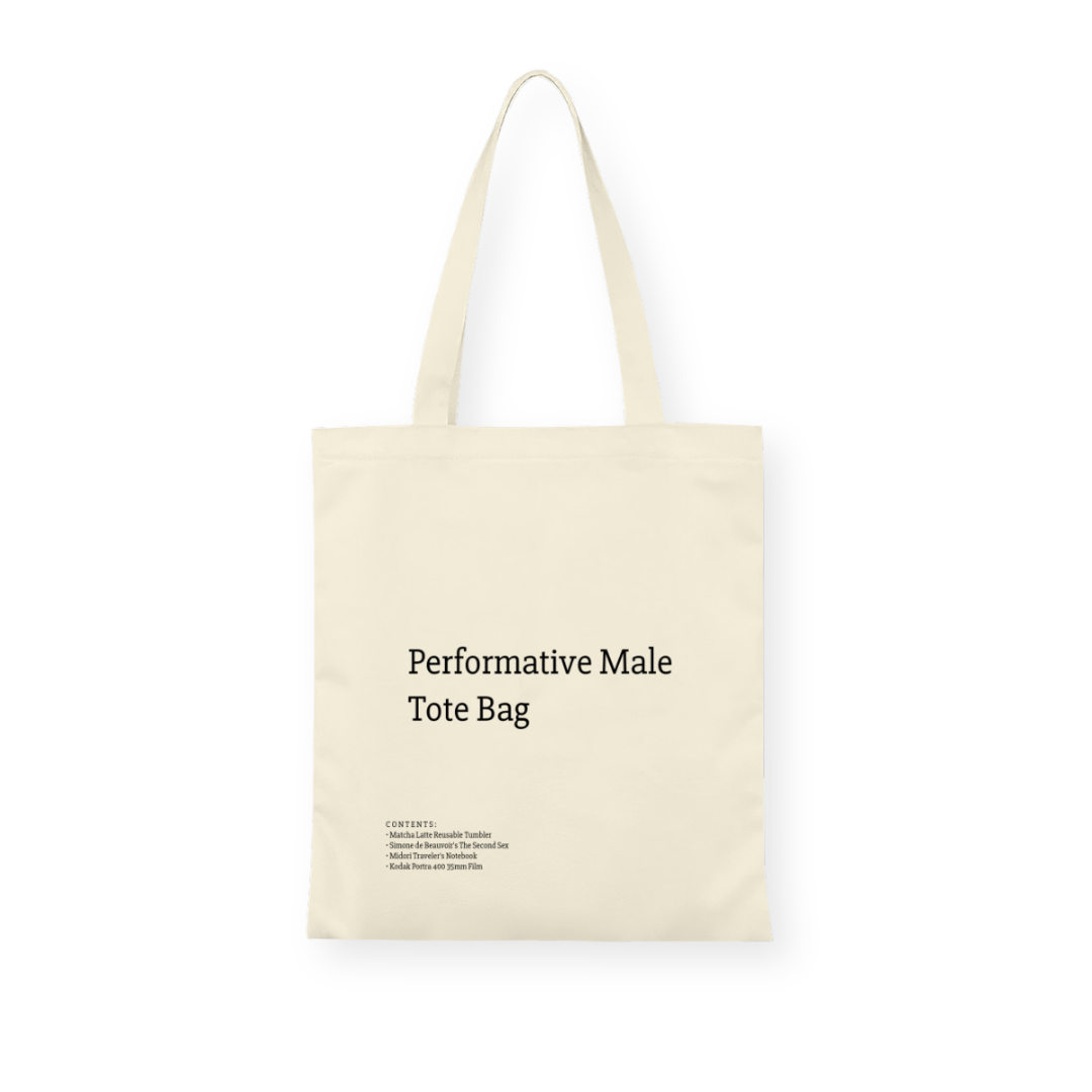 A stylish canvas tote bag featuring a self-aware aesthetic, designed for the modern male shopper. The bag showcases a unique performative design, blending functionality with contemporary art influences, perfect for carrying everyday essentials.
