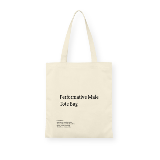 A stylish canvas tote bag featuring a self-aware aesthetic, designed for the modern male shopper. The bag showcases a unique performative design, blending functionality with contemporary art influences, perfect for carrying everyday essentials.