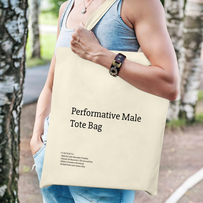 A stylish canvas tote bag featuring a self-aware aesthetic, designed for the modern male shopper. The bag showcases a unique performative design, blending functionality with contemporary art influences, perfect for carrying everyday essentials.