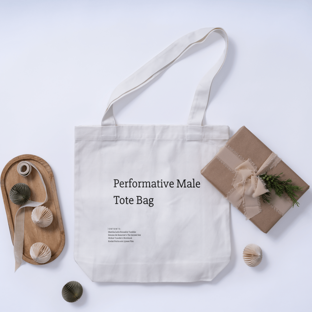 A stylish canvas tote bag featuring a self-aware aesthetic, designed for the modern male shopper. The bag showcases a unique performative design, blending functionality with contemporary art influences, perfect for carrying everyday essentials.